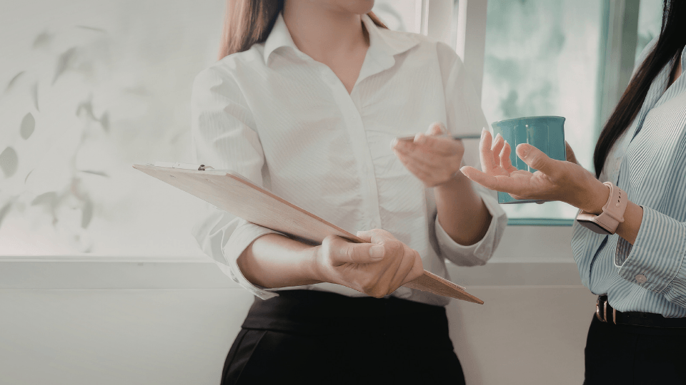 Image of female office worker holding files