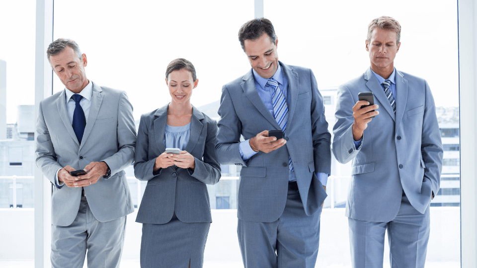 Image of business professionals using their cell phones