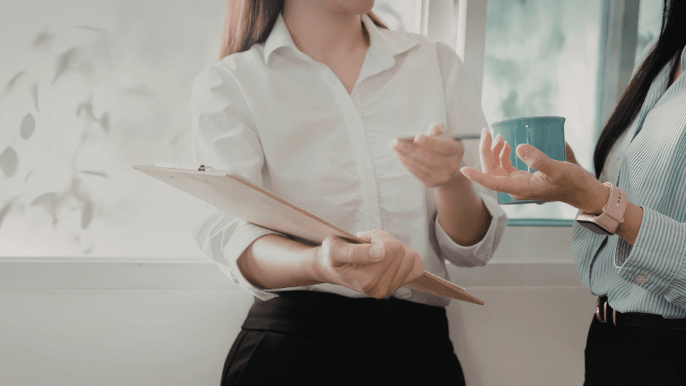 Image of female office worker holding files