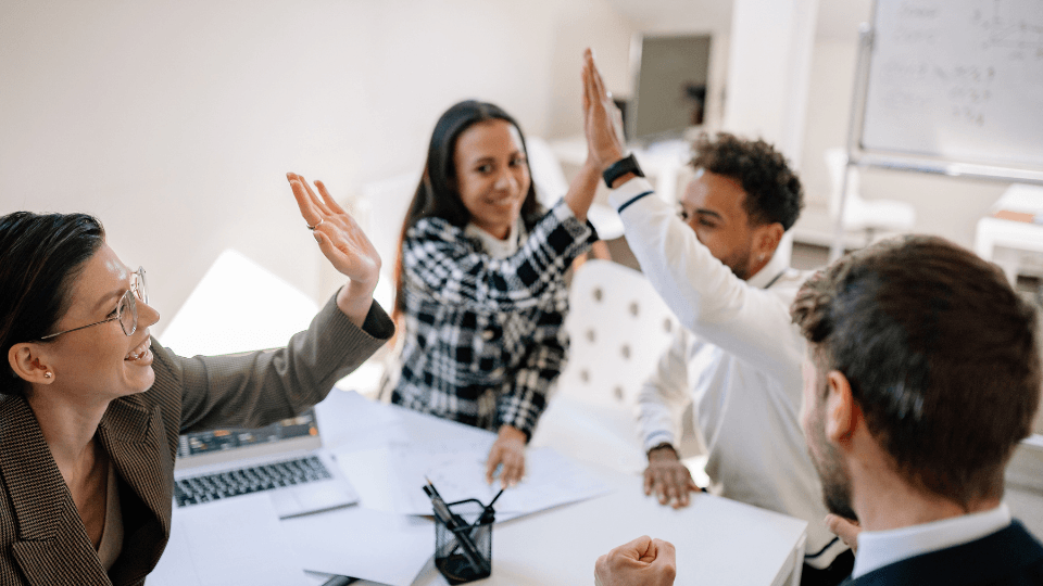 image of team members giving each other high fives